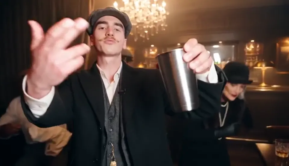 A lead performer in a chandelier-lit party room